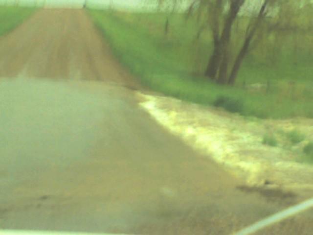 One of the 5 areas of water running across the road leading to our home.