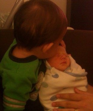 Diego kissing baby brother Alex