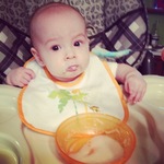 first time in the high chair- cereal with a little bit of apples