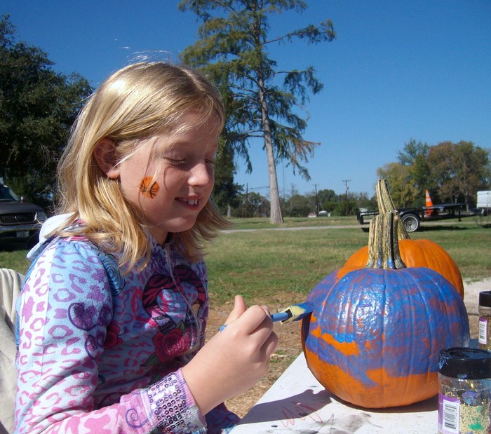 Hannah painting her pumpkin