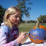 Hannah painting her pumpkin