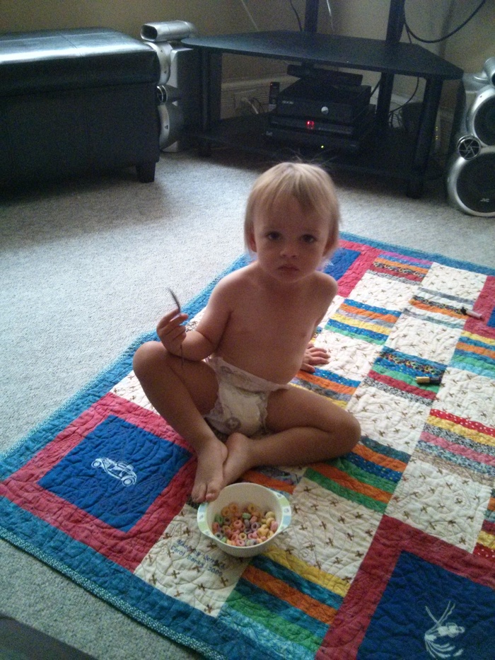 Having a picnic by himself eating fruit loops