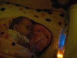 Hannah discovering her light up toy in her crib