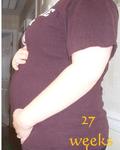 27 weeks... my belly popped at 25 weeks