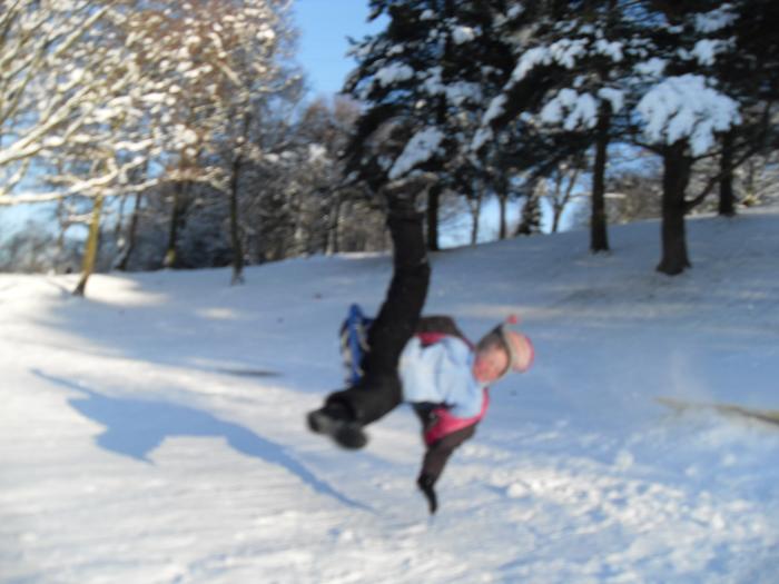 Lia hits a ramp after sledging down hill..