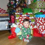 in front of all his gifts. spoiled rotten