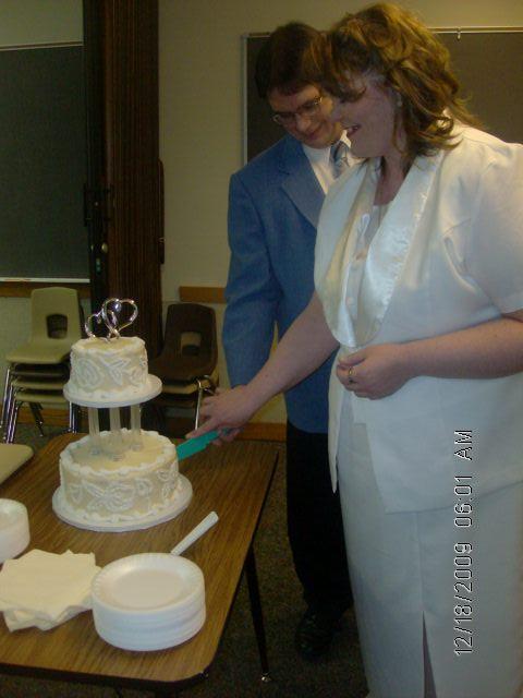 my new hubby and i cutting cake