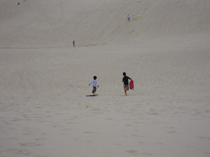 Umi and Jarrah running up the dunes