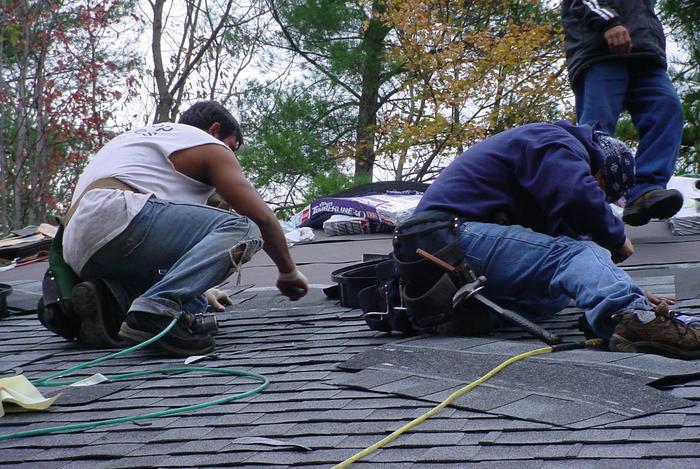 Laying on new roof shingles.