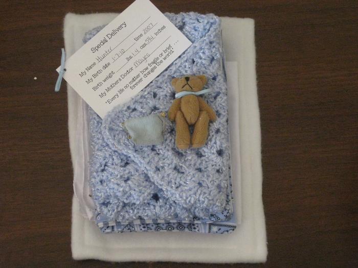 Hunter's little bear, diaper, and blanket he was wrapped in.