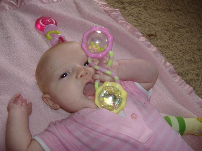 Playing w/ her rattle :)