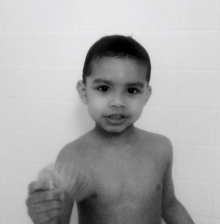 In the tub! (Hes going thru a no sitting in tub phase?)
