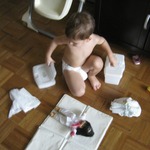 Changing his doll's diaper