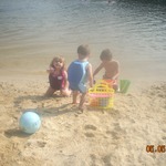 the 3 kids playing at the lake