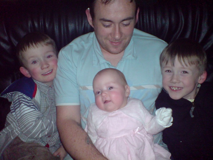 the three munchkins and daddy, christmas past. :)