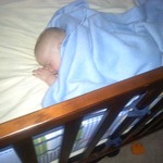 sleeping boy in his crib