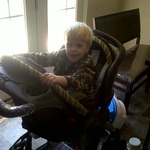 Elijah in the new car seat/stroller "it's fun"