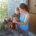 Paul petting the chicken with mommy.