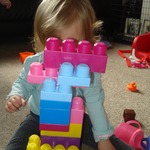 Little Livey is disappearing behind a tower of building blocks, hee hee!! 
