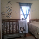 The view of the room from the door. The bed stays till the crib goes.