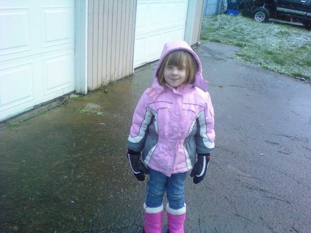 Elizabeth playing in the huge snowflakes this morning while waiting for the bus