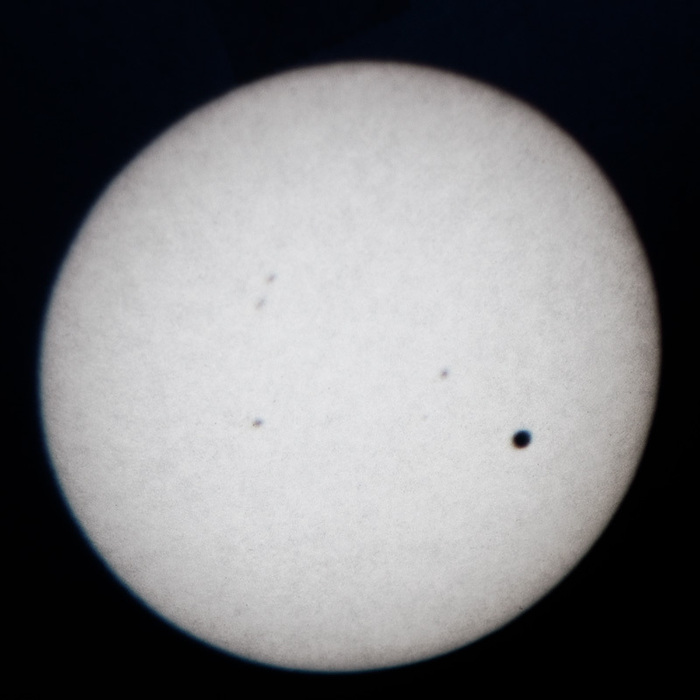 Late in the transit of venus, with sunspots showing.