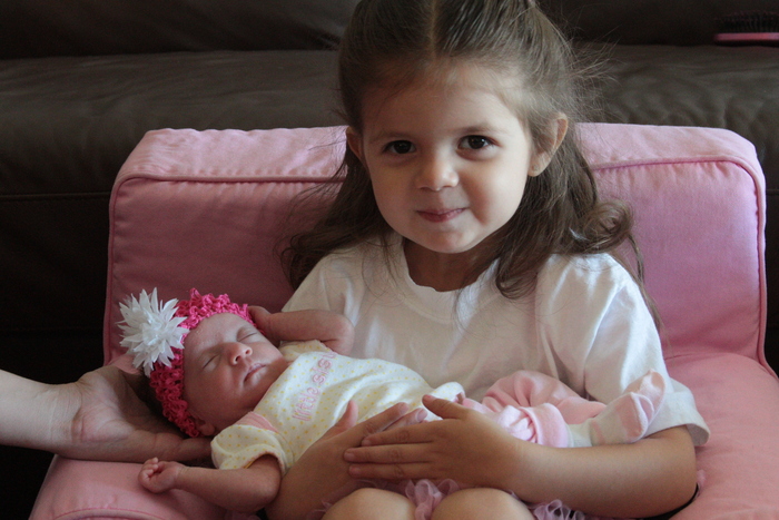 Proud Big Sister holding her new little sister Livie