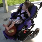 MILEY IN HER WHEELCHAIR AT THE PARK