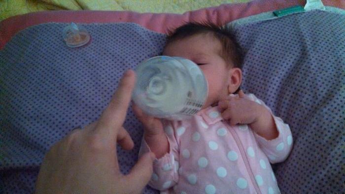 3 weeks old and already trying to hold her own bottle.