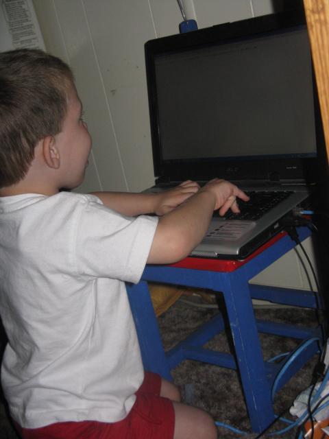 Caleb typing his blog. 