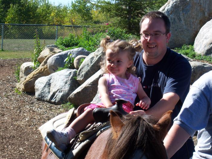 Brianna on a pony right with the help of daddy of course!