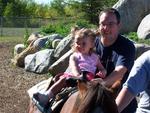 Brianna on a pony right with the help of daddy of course!