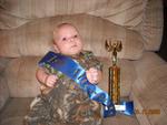 Bubby showing off his trophy and sash to Grandma