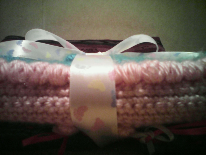 baby blanket wrapped in ribbon