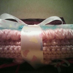baby blanket wrapped in ribbon