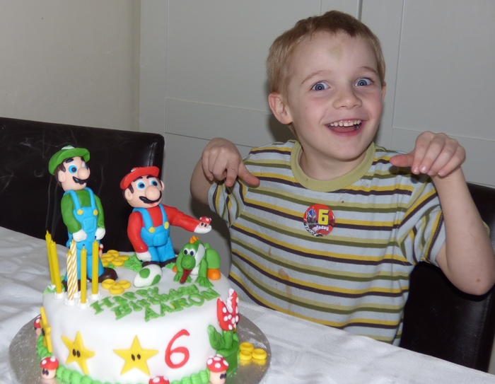 Aaron happy with his Mario, Luigi and Yoshi cake 20.2.2014