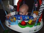 playing in his jumperoo