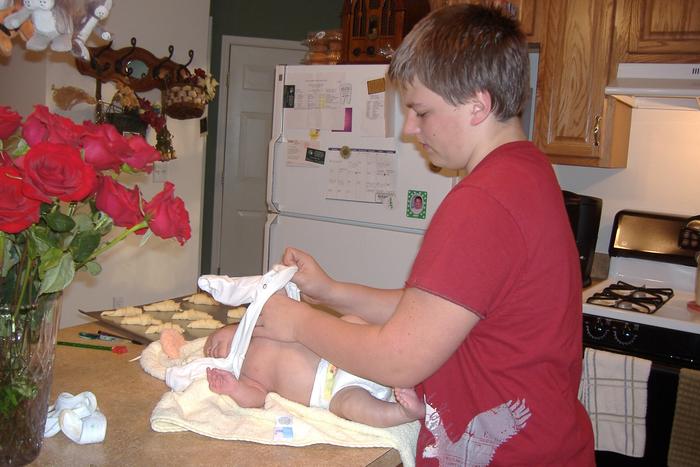 Big brother Owen (13) dressing the baby after his bath.. something his "father" has never done