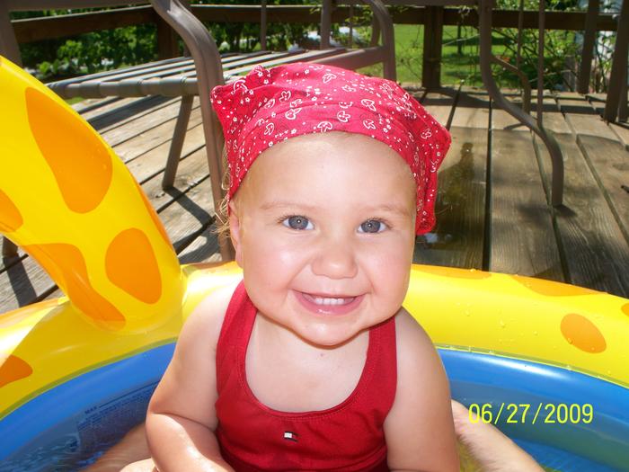 my beautiful baby girl playing in her pool