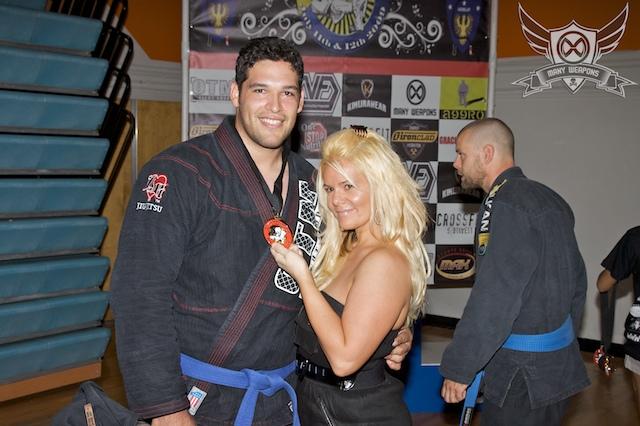 Mommy holding Daddy's Gold Medal ~after winning 1st place in JiuJitSu Mma fighting!