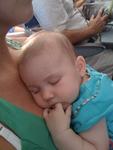 sleepin on mommy on the plane of course finger in mouth