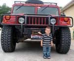 Standing proudly by a friend's Hummer