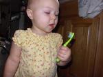 Brushing her teeth for the first time ( all by herself)
